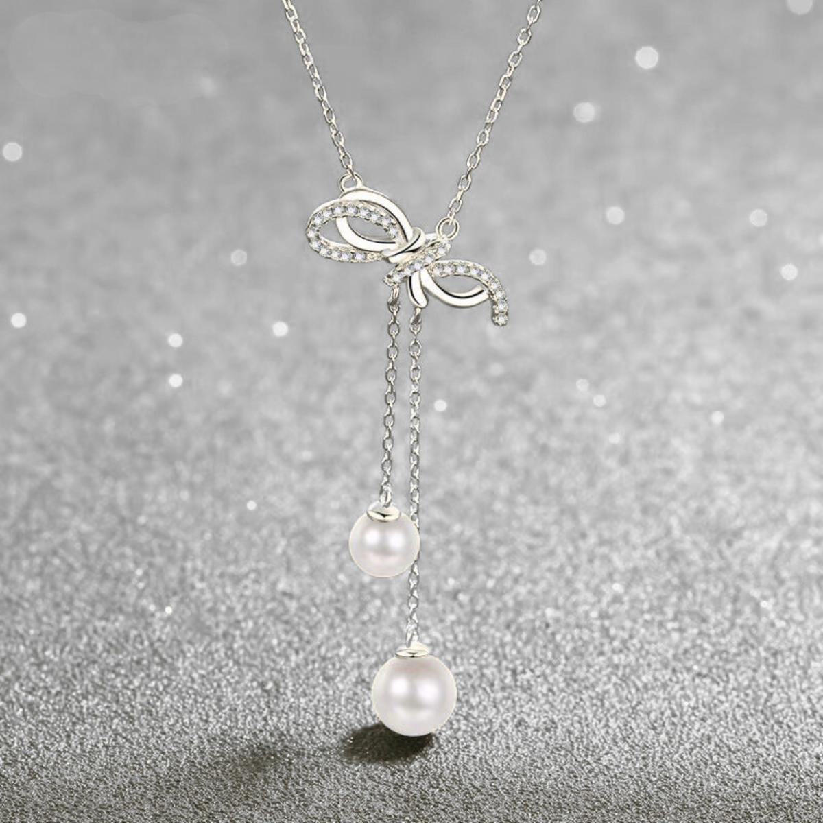 Collana fiocco con perle naturali e moissanite
