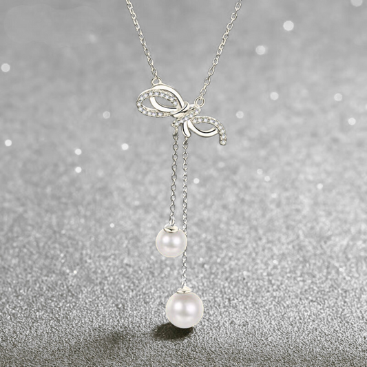 Collana fiocco con perle naturali e moissanite
